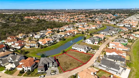 an aerial view of a swimming pool with outdoor seating and yard