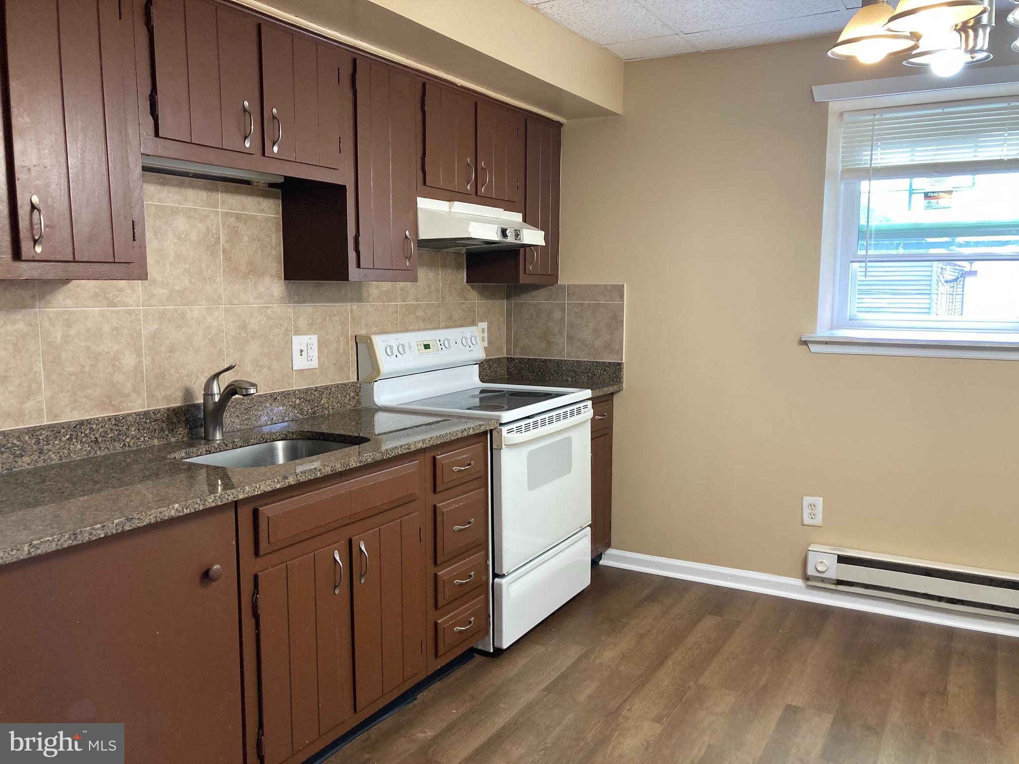 102 Delaware Road, Unit 3 Riegelsville, PA 18077 - Photo 2 of 11 a kitchen with stainless steel appliances granite countertop a sink a stove and cabinets