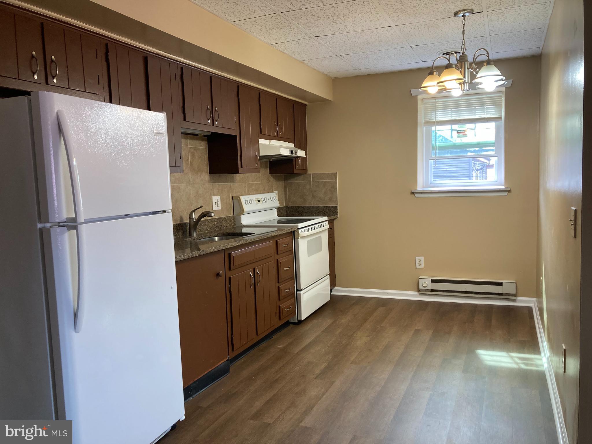 102 Delaware Road, Unit 3 Riegelsville, PA 18077 - Photo 3 of 11 a kitchen with stainless steel appliances a refrigerator sink and microwave