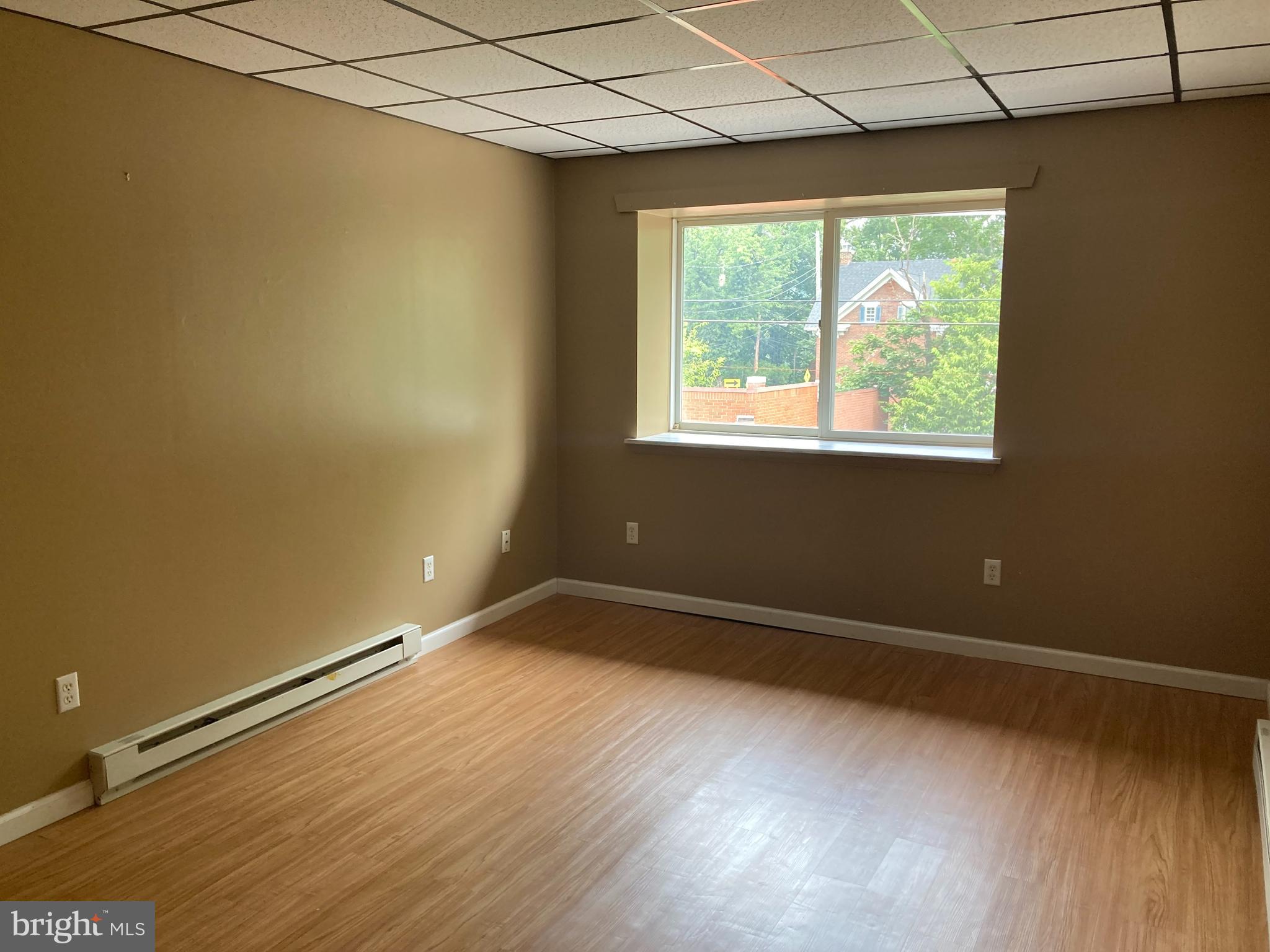 102 Delaware Road, Unit 3 Riegelsville, PA 18077 - Photo 4 of 11 an empty room with wooden floor and windows