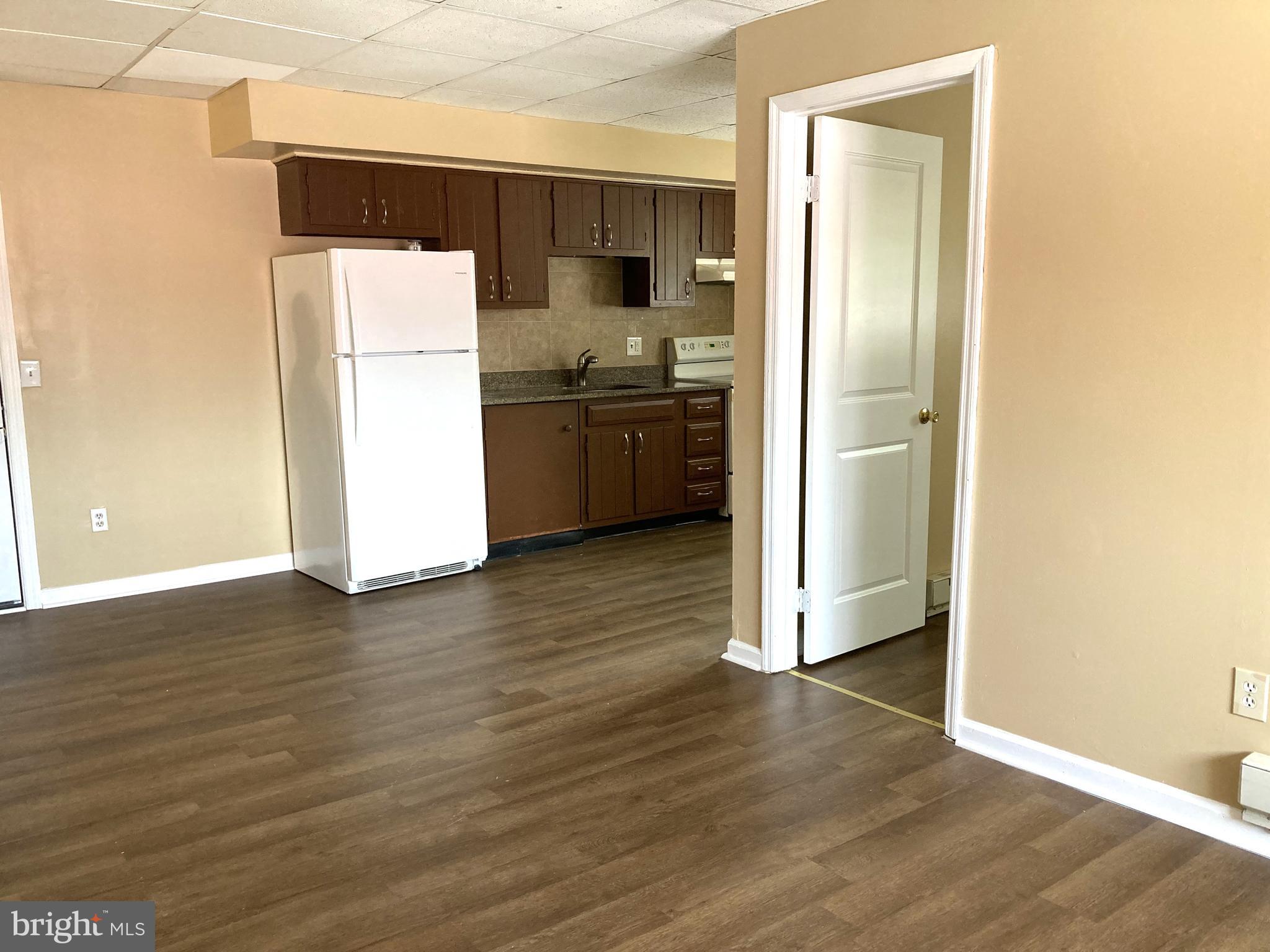 102 Delaware Road, Unit 3 Riegelsville, PA 18077 - Photo 5 of 11 a kitchen with a refrigerator and a stove top oven