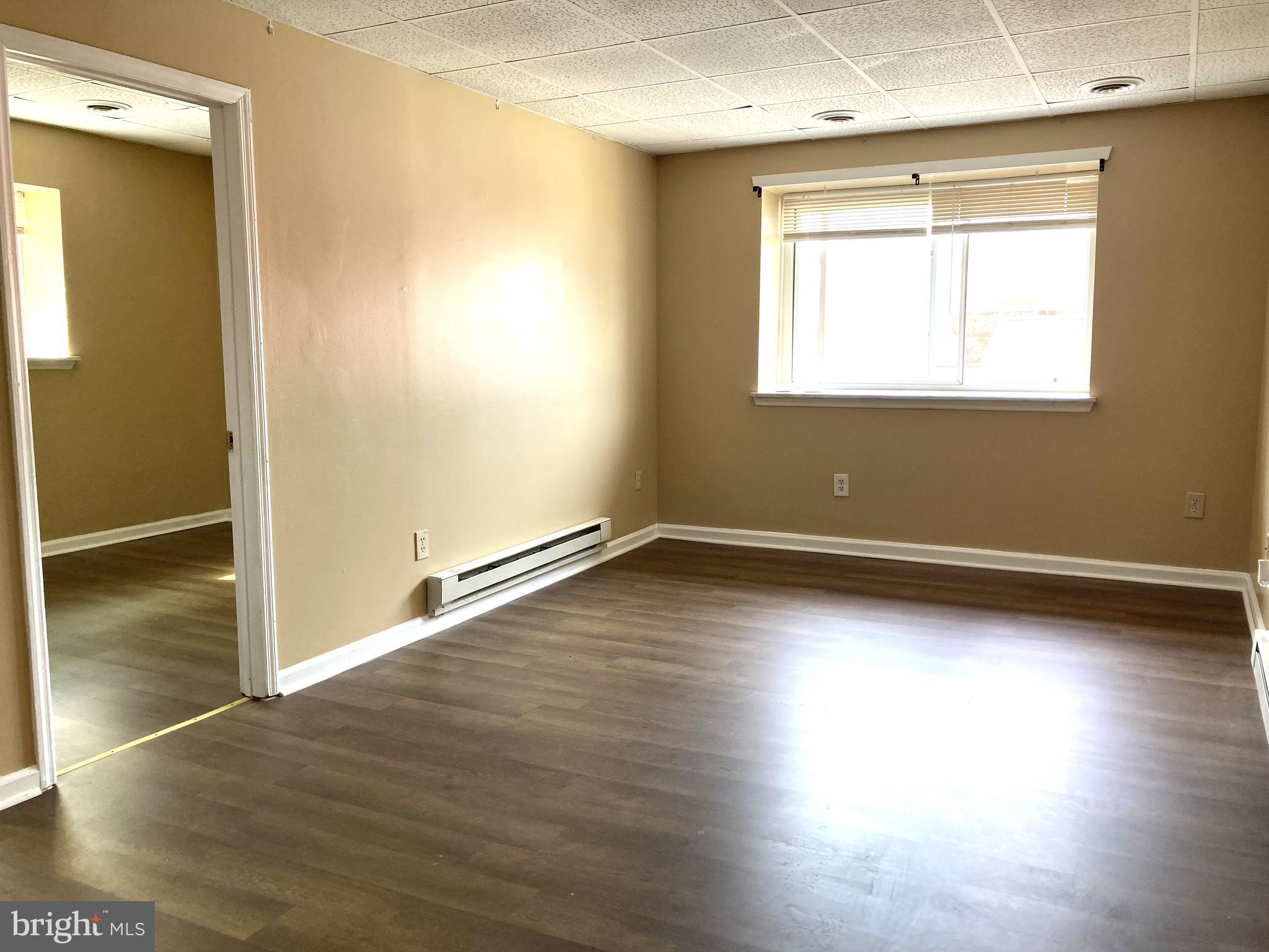 102 Delaware Road, Unit 3 Riegelsville, PA 18077 - Photo 6 of 11 an empty room with wooden floor and windows