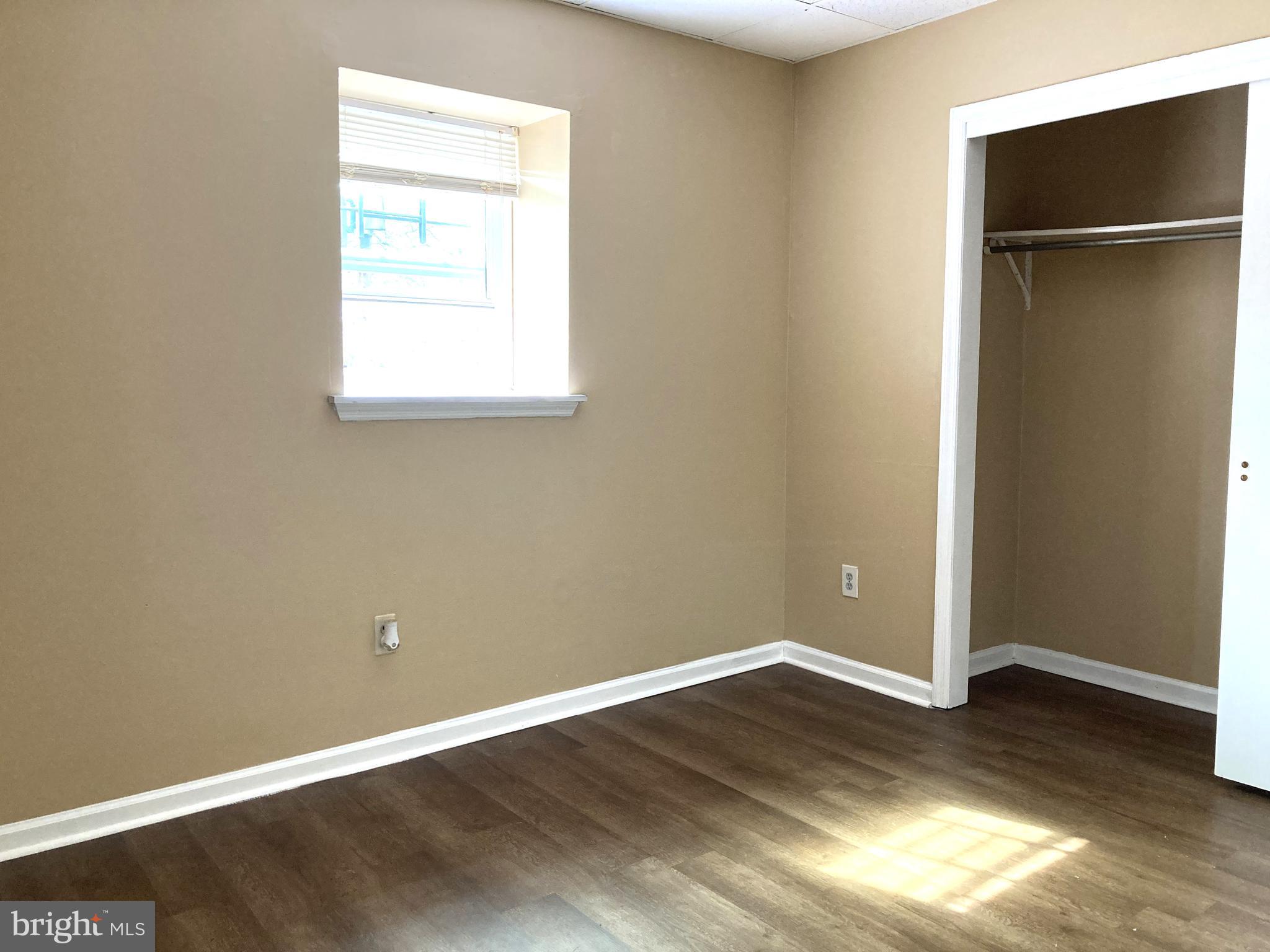 102 Delaware Road, Unit 3 Riegelsville, PA 18077 - Photo 8 of 11 an empty room with wooden floor and a window