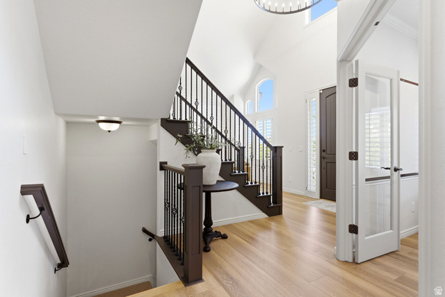 1712 Somerset Ridge Drive Draper, UT 84020 - Photo 6 of 76 Two-story foyer featuring high vaulted ceilings, light wood-finish flooring, and a dark wood staircase with wrought iron balusters