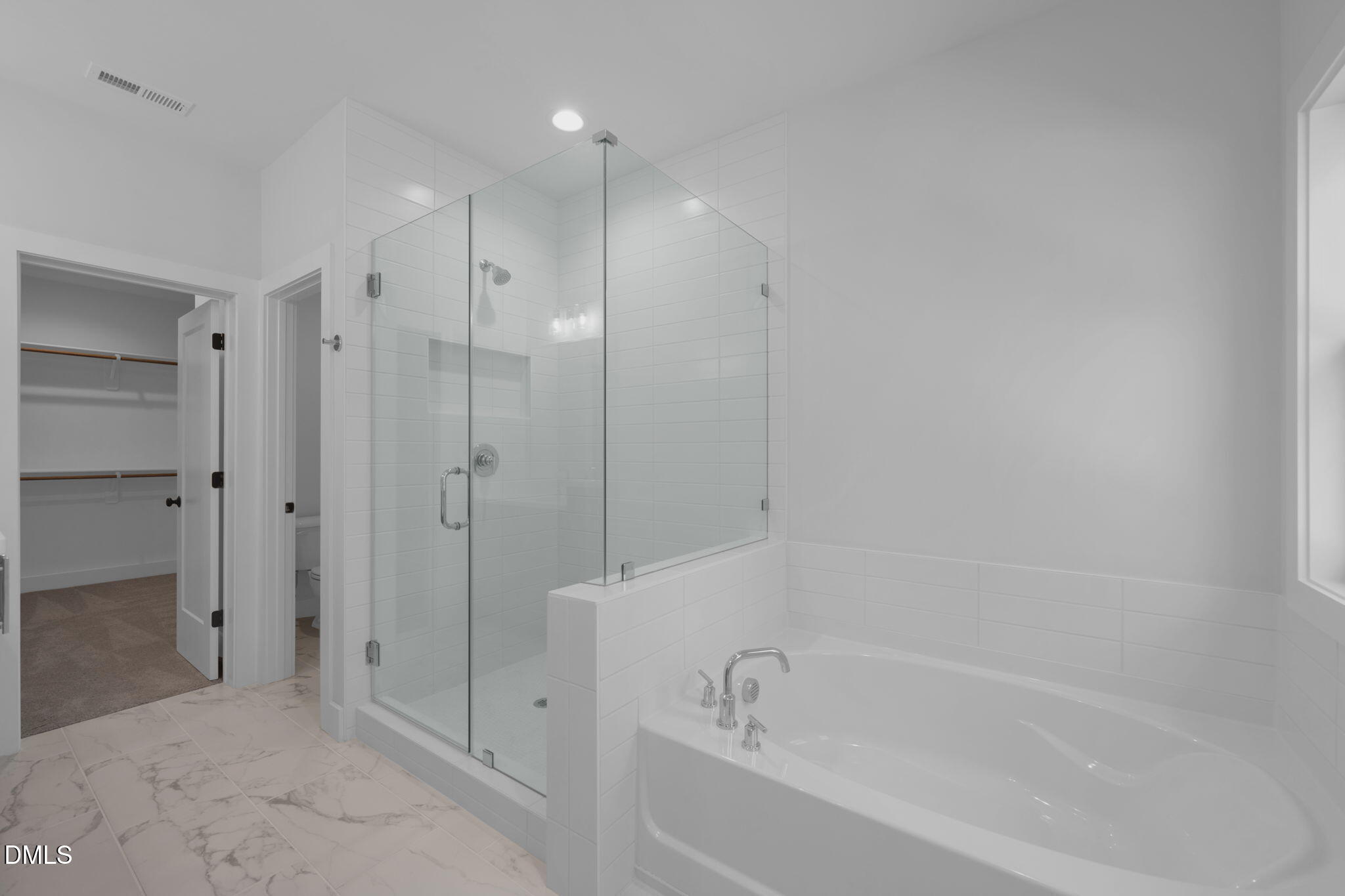 966 Double Helix Road Apex, NC 27523 - Photo 18 of 36 a bathroom with a bathtub and a shower