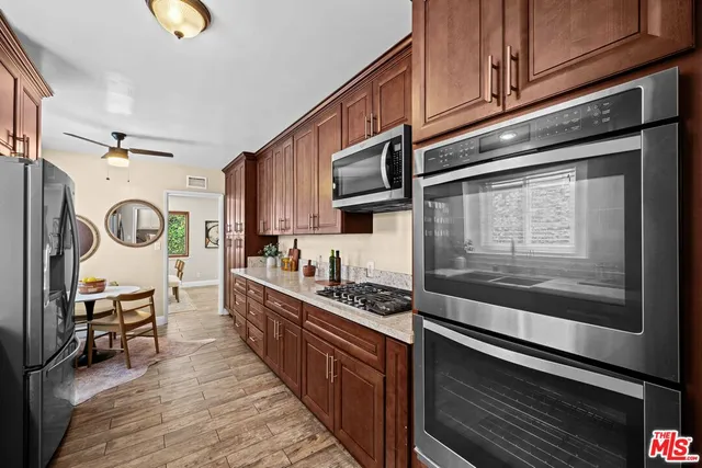 a kitchen with stainless steel appliances granite countertop a stove and a sink