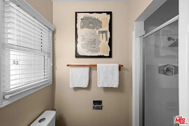 a bathroom with a shower and a window