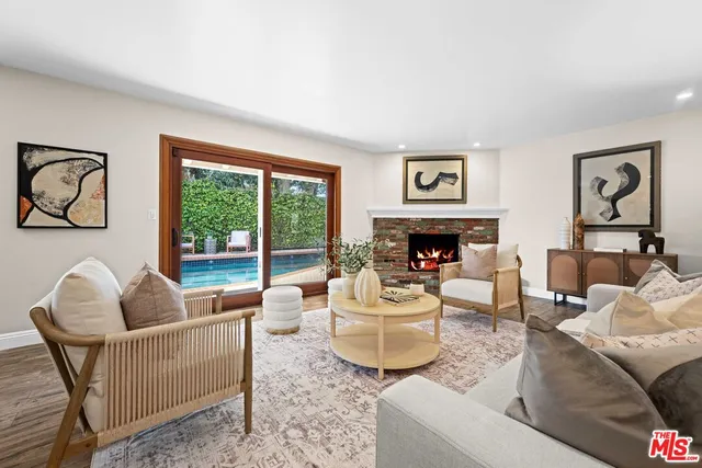 a living room with furniture fireplace and window