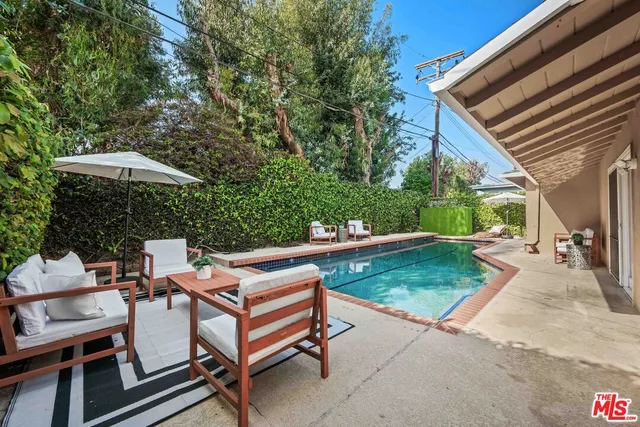 a view of a house with backyard sitting area and tub