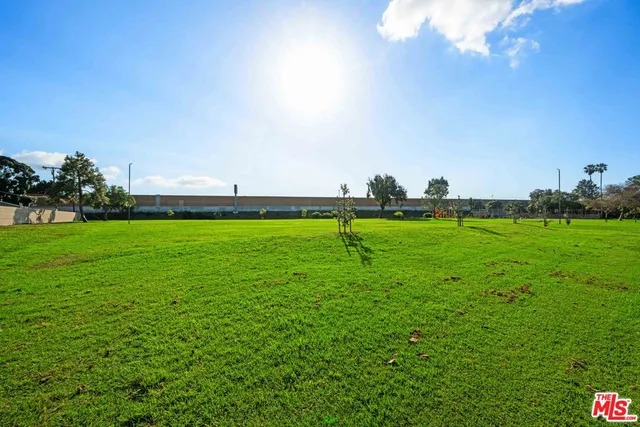 a view of outdoor space with a garden and signage