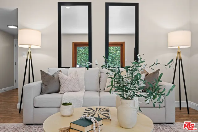 a living room with furniture and a potted plant