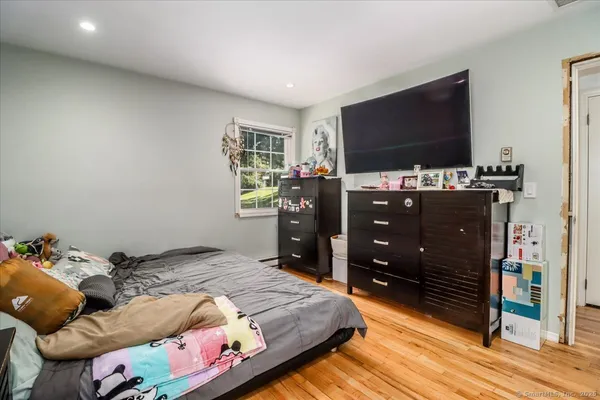a bedroom with a bed and a flat screen tv