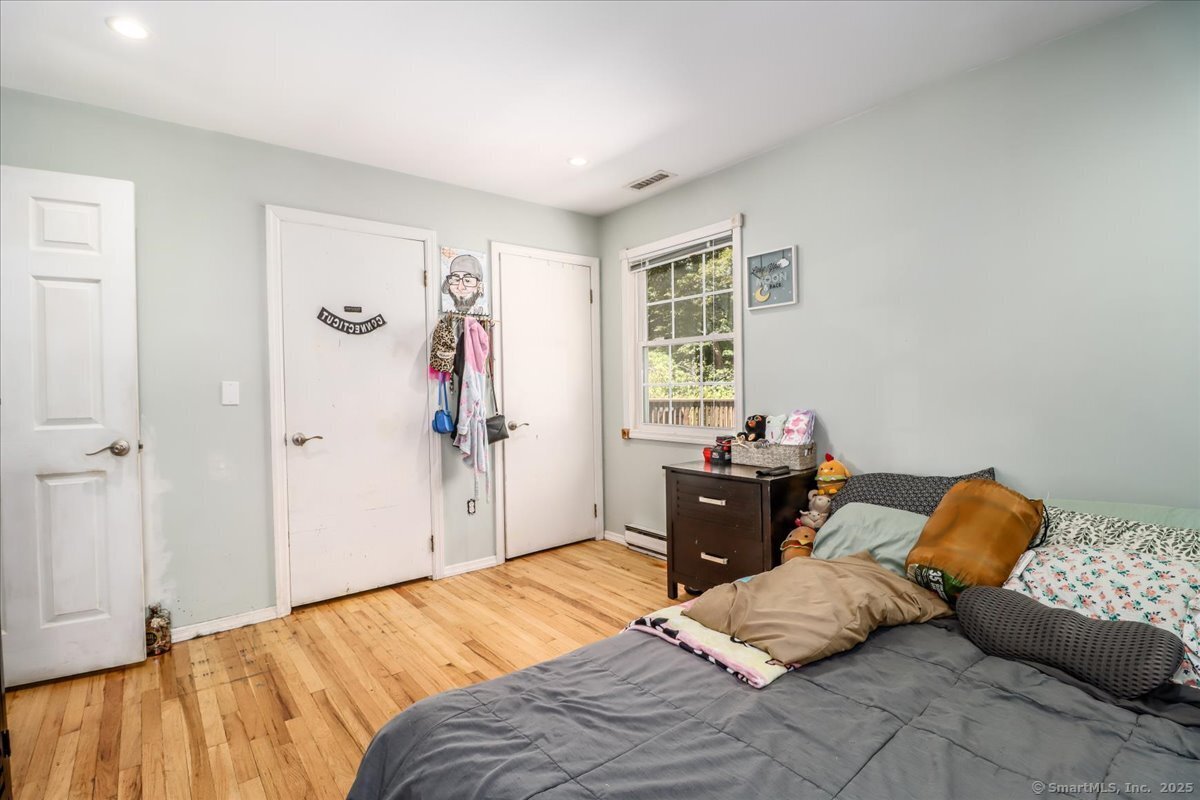 35 Hillendale Drive New Milford, CT 06776 - Photo 12 of 39 a bedroom with a bed and wooden floor