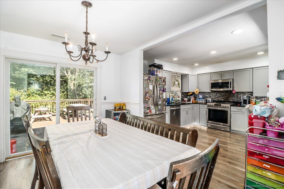 35 Hillendale Drive New Milford, CT 06776 - Photo 15 of 39 a view of a dining room and livingroom with furniture wooden floor a chandelier