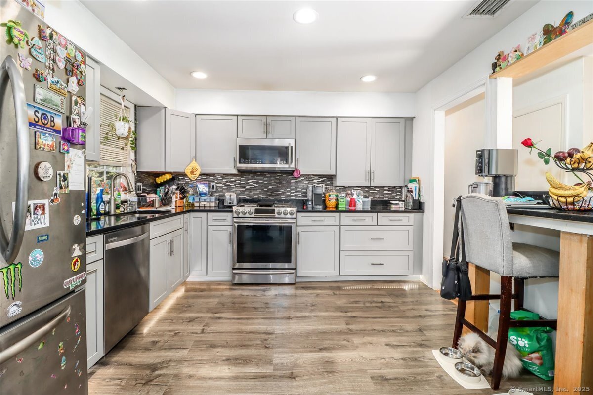 35 Hillendale Drive New Milford, CT 06776 - Photo 19 of 39 a kitchen with stainless steel appliances kitchen island granite countertop a refrigerator sink and stove top oven