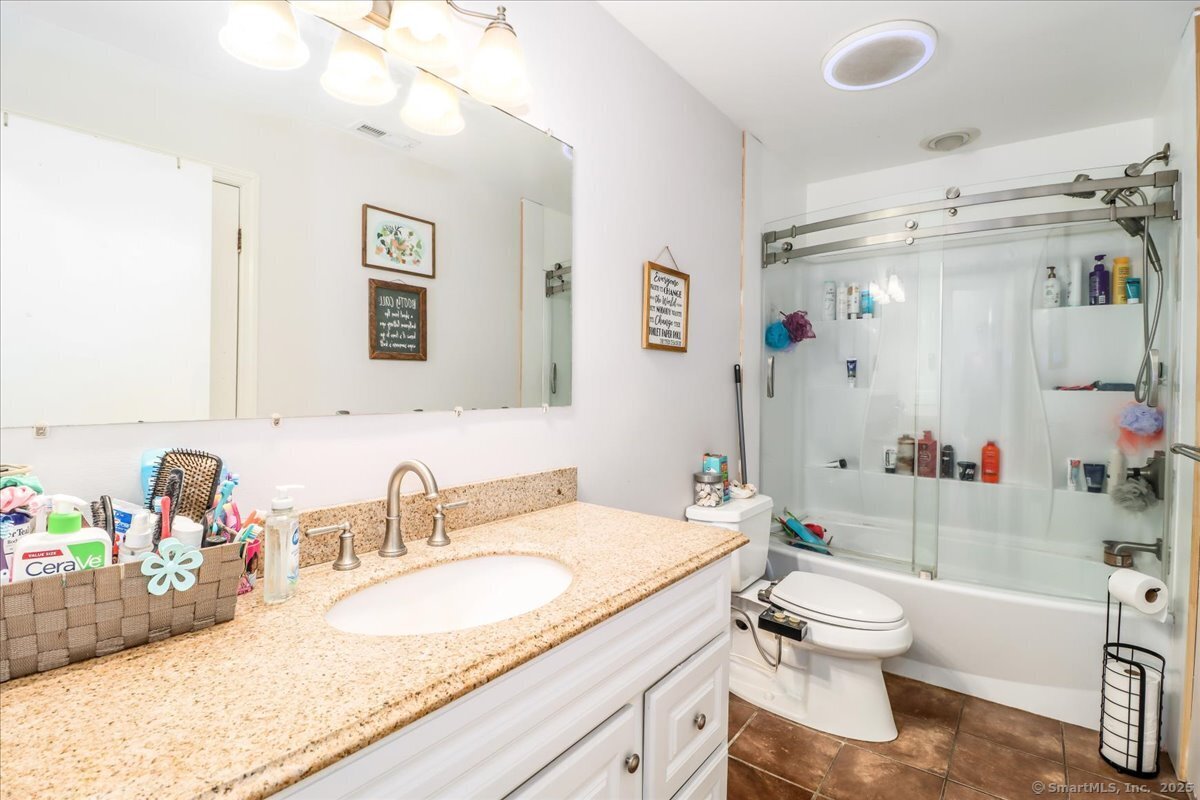 35 Hillendale Drive New Milford, CT 06776 - Photo 20 of 39 a bathroom with a granite countertop sink mirror vanity and toilet