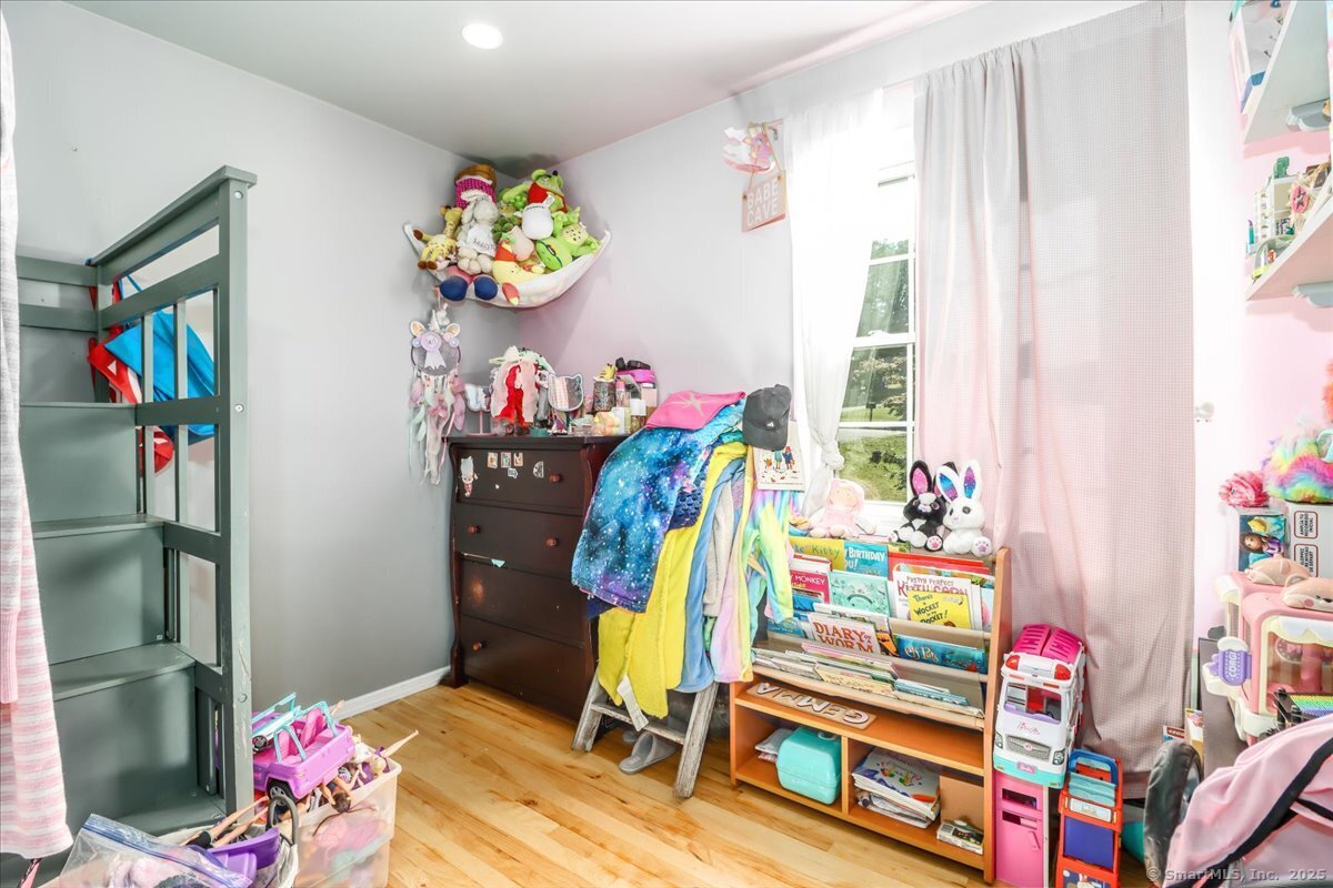 35 Hillendale Drive New Milford, CT 06776 - Photo 24 of 39 a bedroom with a bed and a chandelier