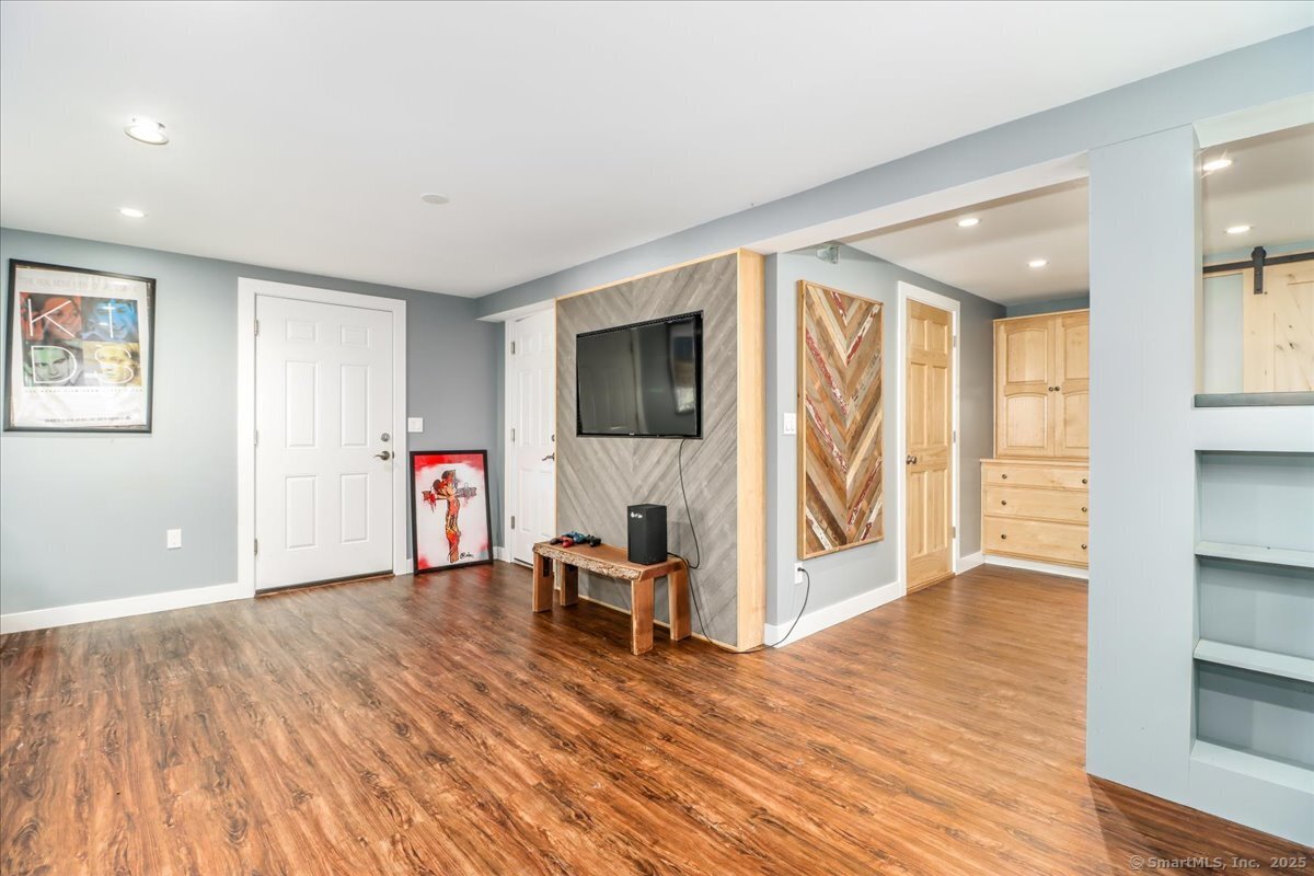 35 Hillendale Drive New Milford, CT 06776 - Photo 28 of 39 a view of an empty room with wooden floor and a window