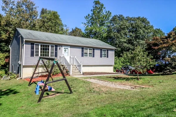 a view of a house with backyard and a slide