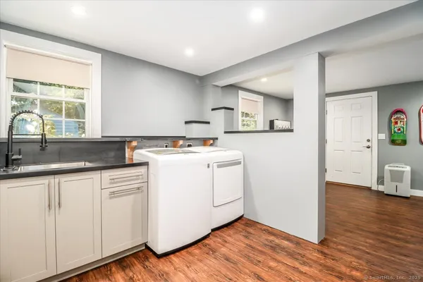 a kitchen with granite countertop white cabinets and white appliances