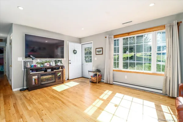 a living room with a large window and a flat screen tv