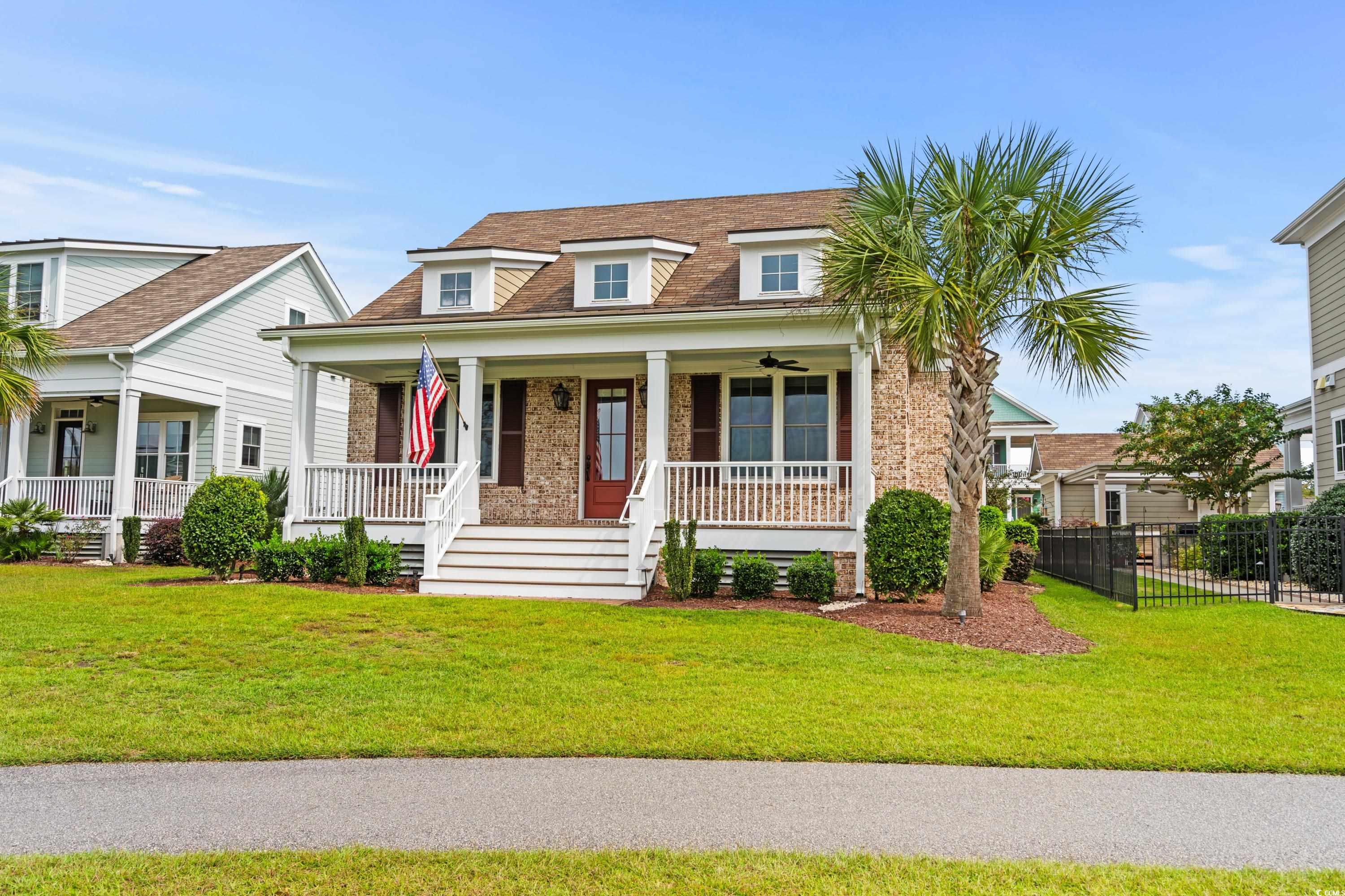 8159 Sandlapper Way Myrtle Beach, SC 29572 - Photo 1 of 39 View of front facade with a front lawn and covered