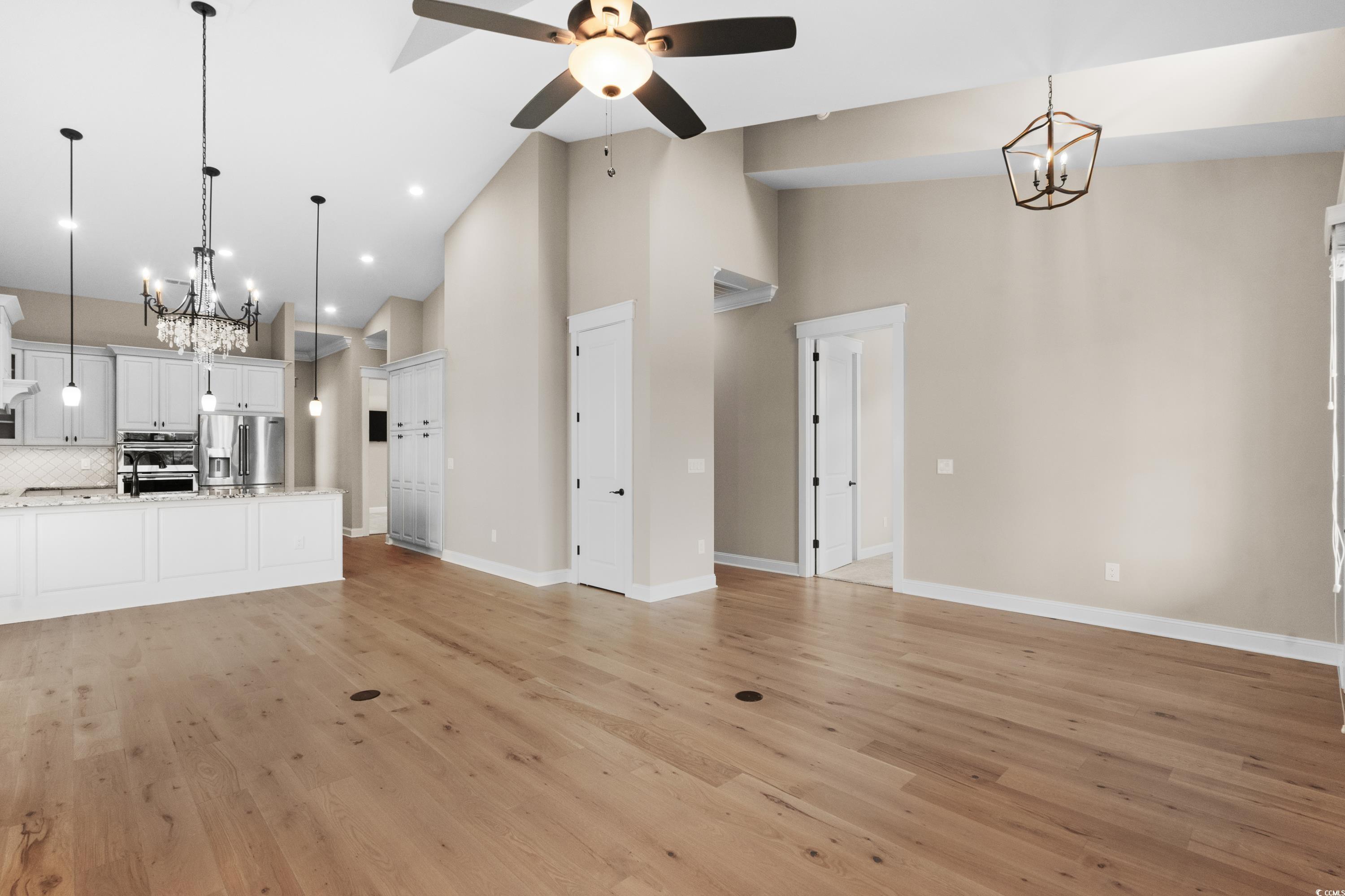 8159 Sandlapper Way Myrtle Beach, SC 29572 - Photo 14 of 39 Unfurnished living room with ceiling fan with nota