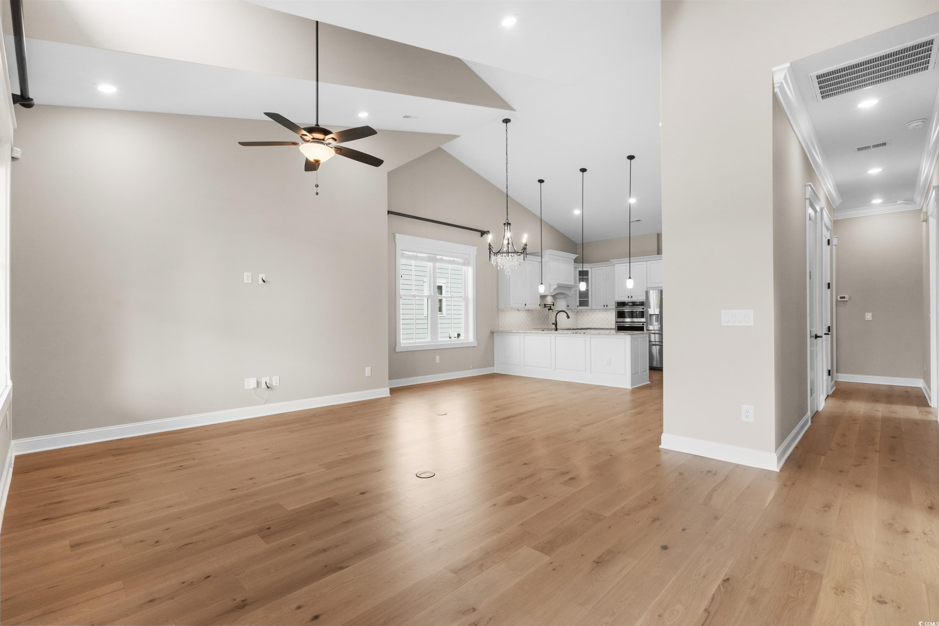 8159 Sandlapper Way Myrtle Beach, SC 29572 - Photo 15 of 39 Unfurnished living room with crown molding, sink,