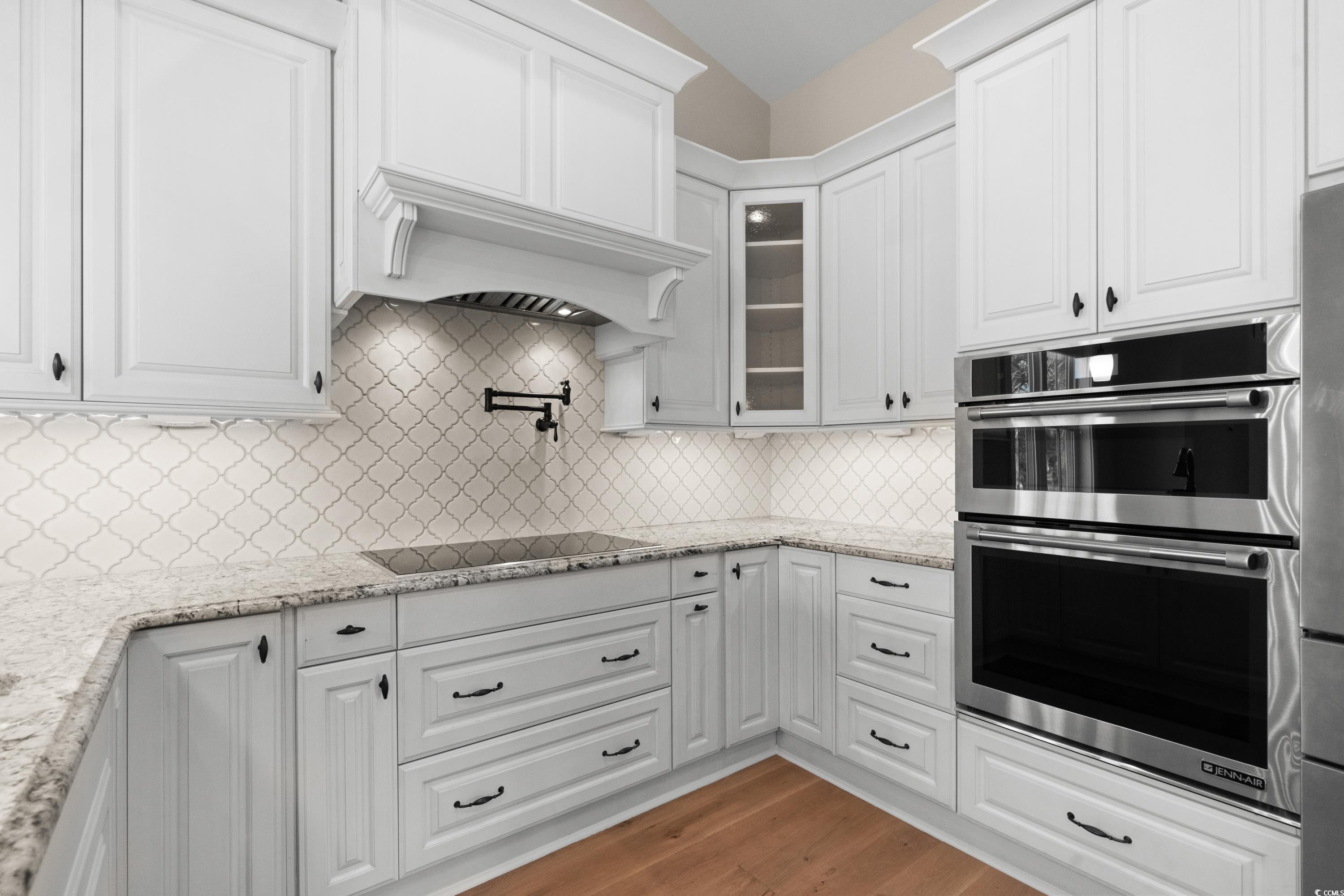 8159 Sandlapper Way Myrtle Beach, SC 29572 - Photo 19 of 39 Kitchen with black electric cooktop, light hardwoo