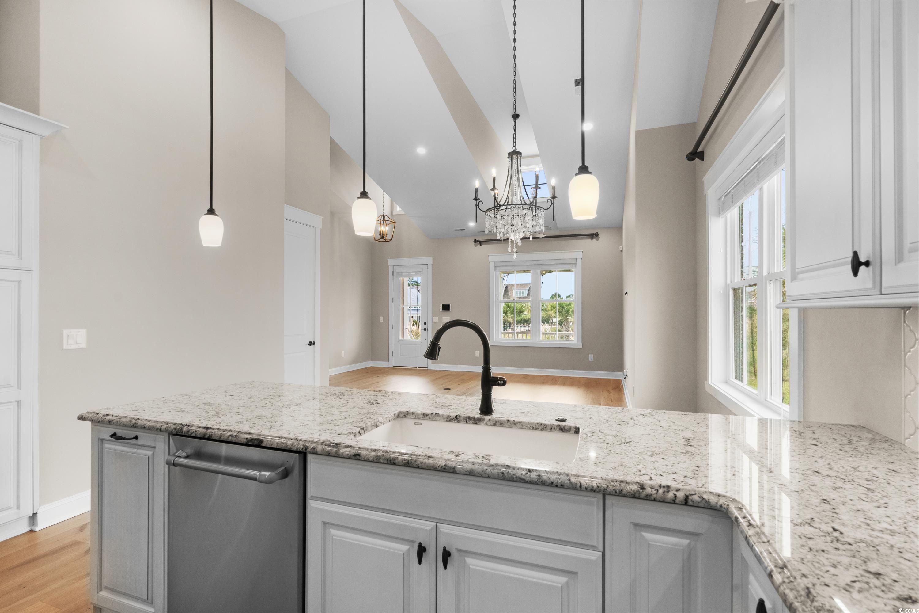8159 Sandlapper Way Myrtle Beach, SC 29572 - Photo 20 of 39 Kitchen featuring a chandelier, sink, white cabine