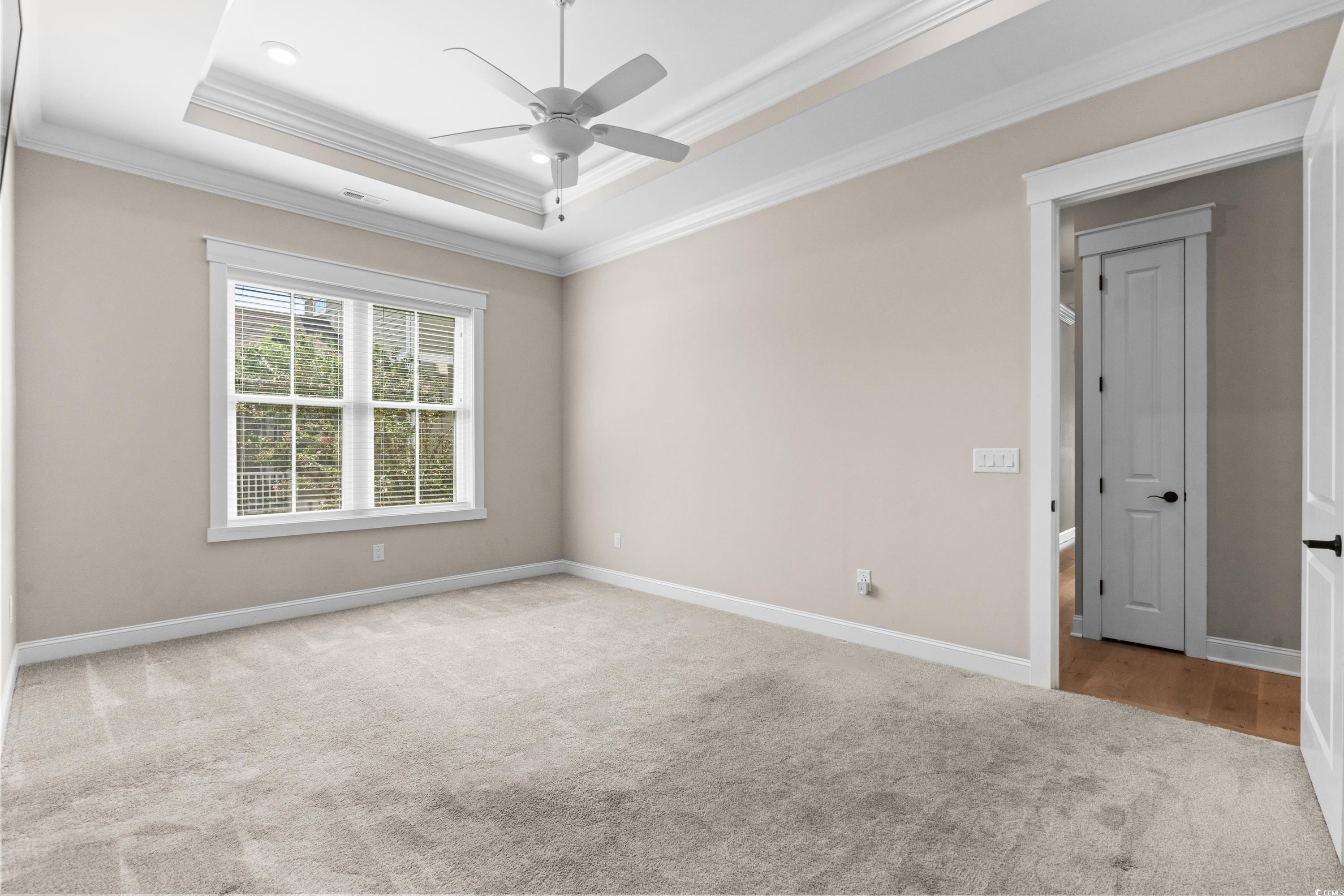 8159 Sandlapper Way Myrtle Beach, SC 29572 - Photo 22 of 39 Carpeted spare room with ceiling fan, a tray ceili