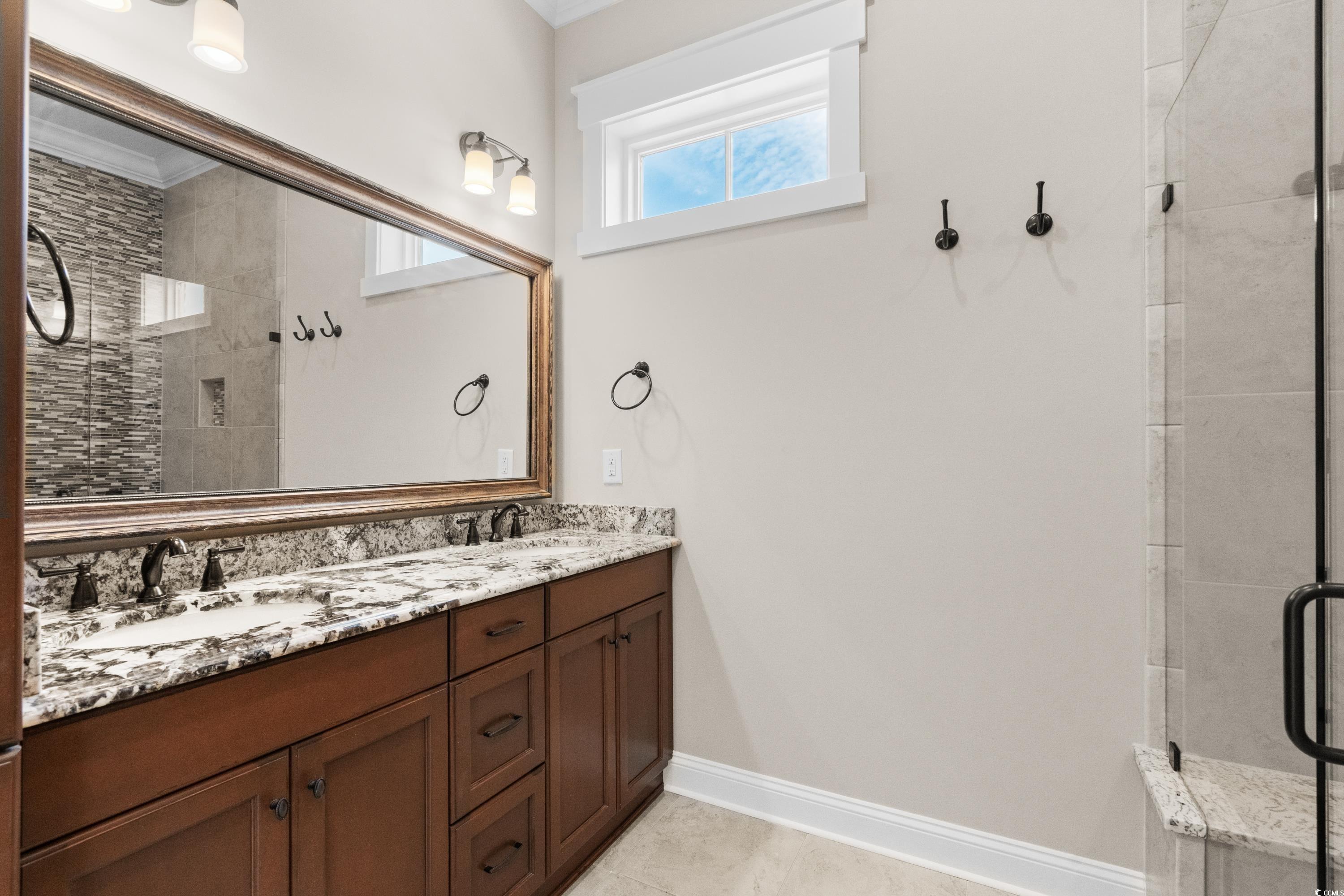 8159 Sandlapper Way Myrtle Beach, SC 29572 - Photo 23 of 39 Bathroom with vanity, tile patterned flooring, and