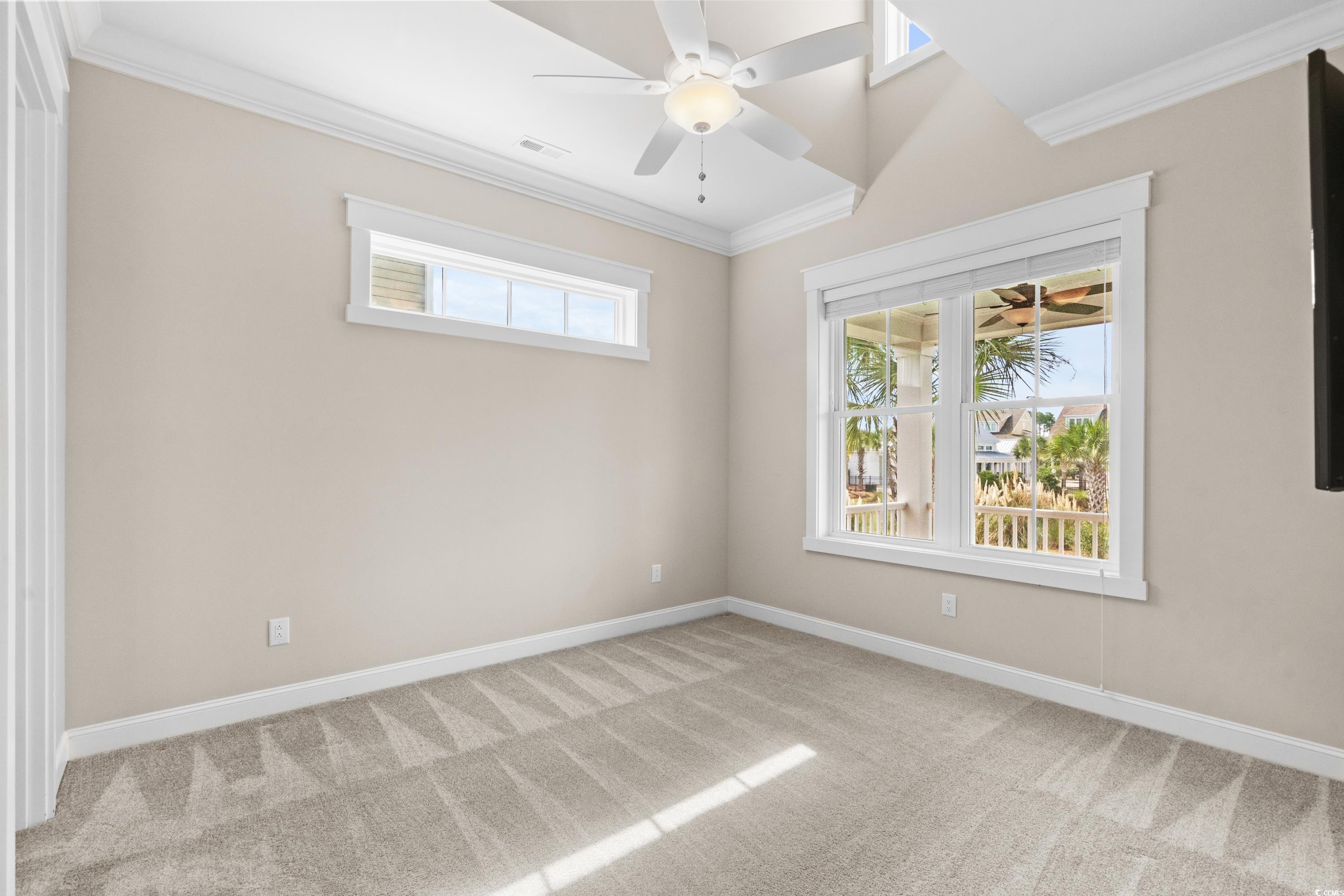 8159 Sandlapper Way Myrtle Beach, SC 29572 - Photo 29 of 39 Spare room featuring crown molding, ceiling fan, a