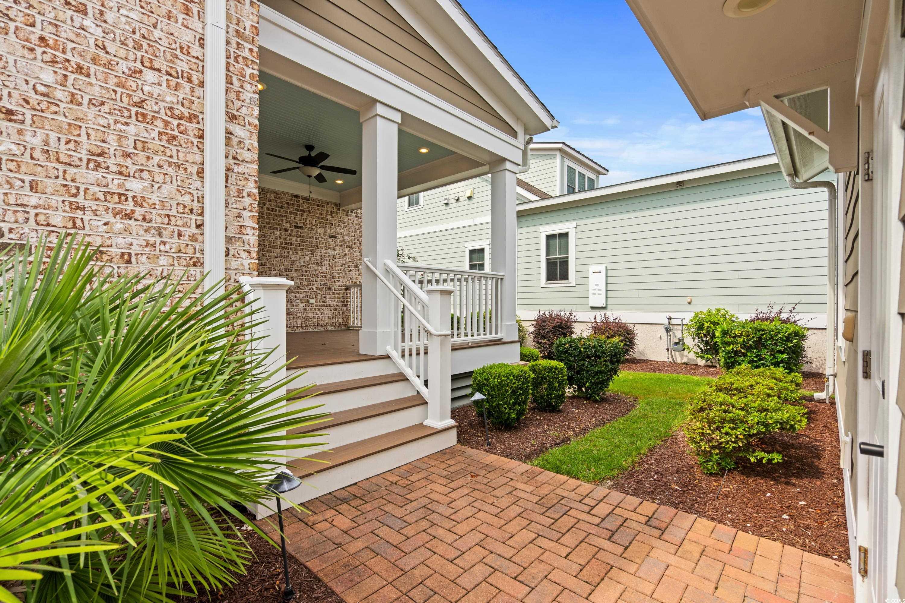 8159 Sandlapper Way Myrtle Beach, SC 29572 - Photo 7 of 39 View of exterior entry featuring ceiling fan and c
