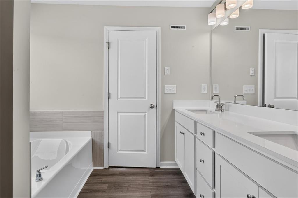 107 Ledgemont Way Acworth, GA 30101 - Photo 39 of 57 a bathroom with a tub a sink and mirrors