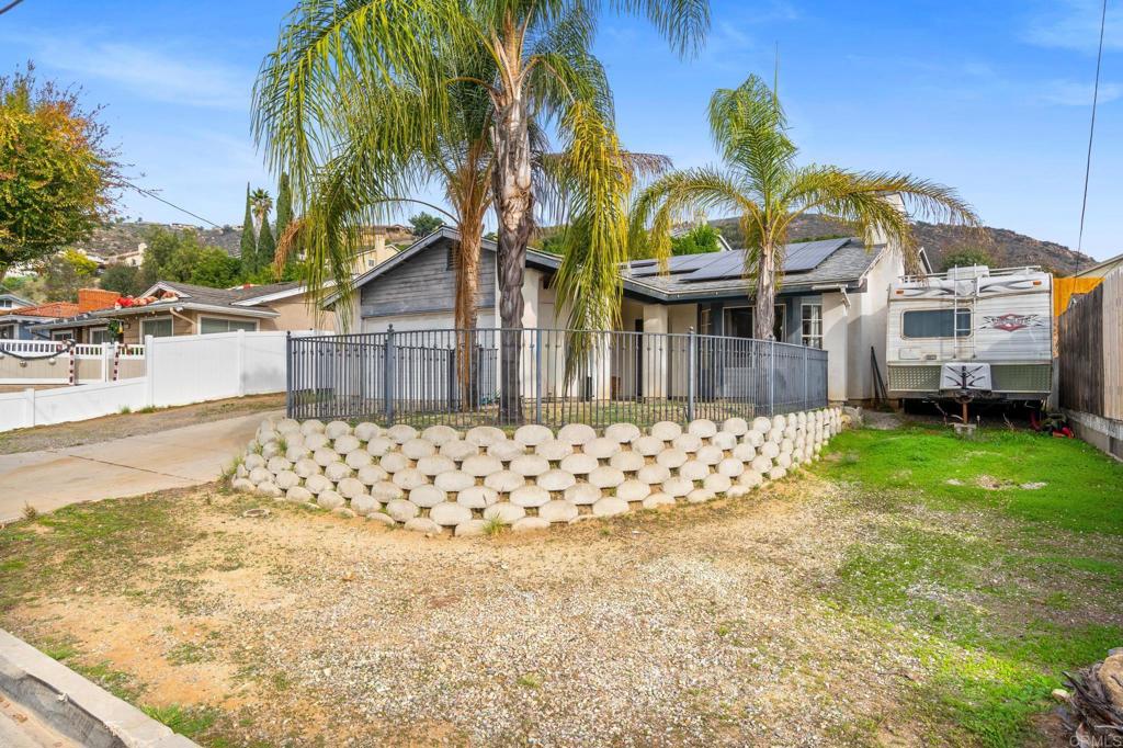 8321 Sheila Street El Cajon, CA 92021 - Photo 2 of 26 a front view of a house with a yard