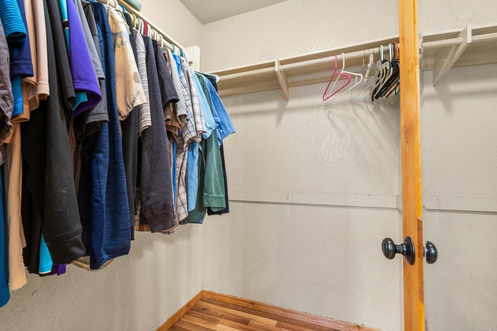 8321 Sheila Street El Cajon, CA 92021 - Photo 21 of 26 a view of walk in closet with clothes and shoes