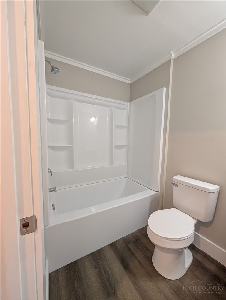 68 Estep Street Sparta, NC 28675 - Photo 12 of 21 a white toilet sitting next to a bath tub