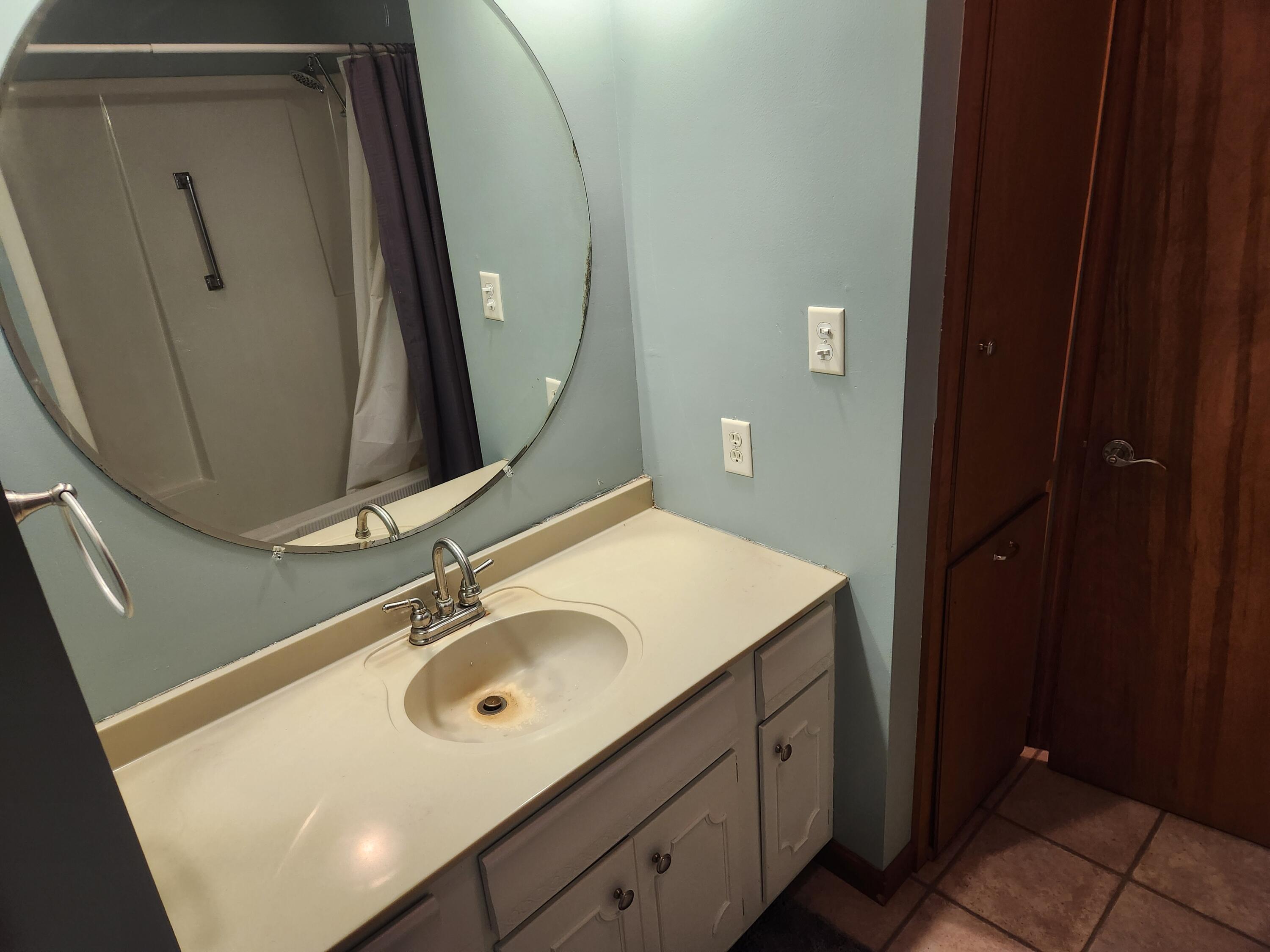 4726 Locksley Drive East Rensselaer, IN 47978 - Photo 23 of 33 a bathroom with a sink vanity and a mirror