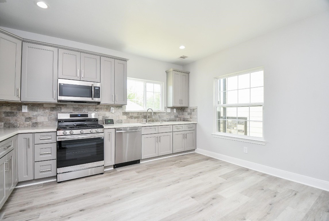 8336 Fountain Street Houston, TX 77051 - Photo 12 of 34 a kitchen with granite countertop white cabinets and appliances