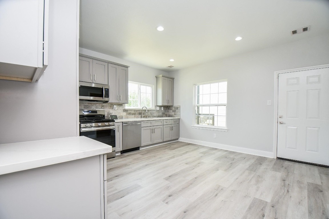 8336 Fountain Street Houston, TX 77051 - Photo 13 of 34 a kitchen with a white cabinets and white appliances