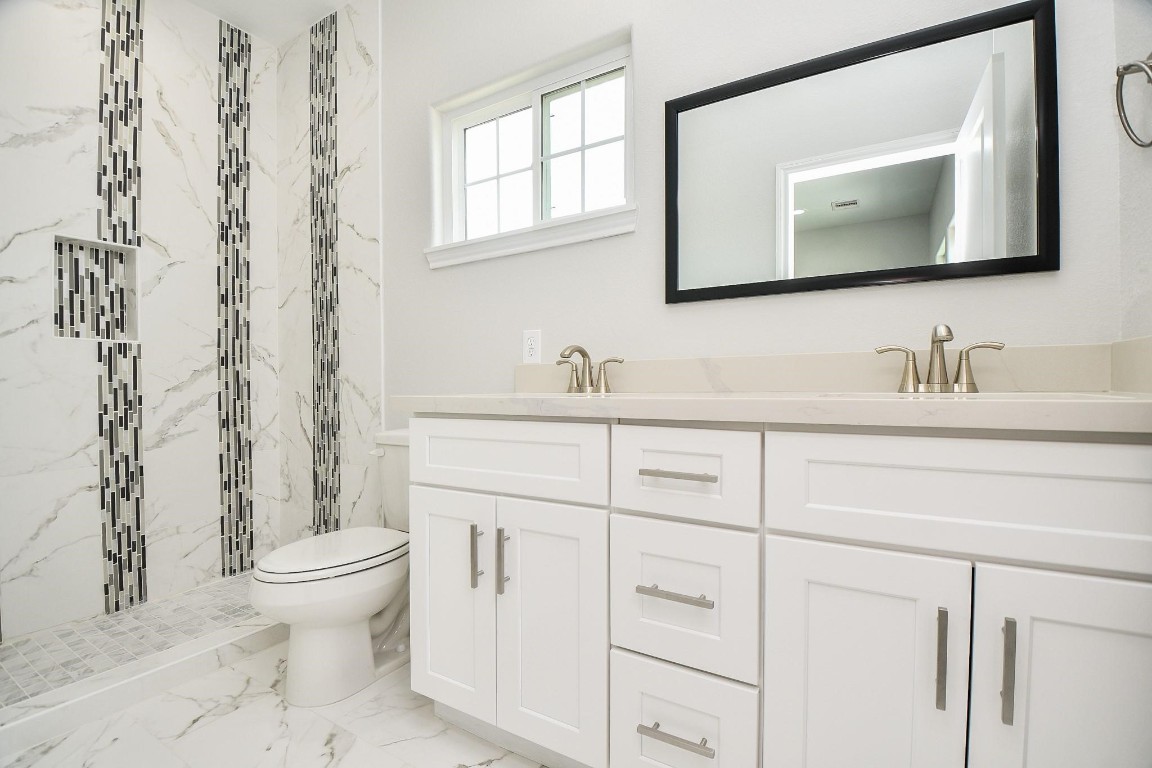 8336 Fountain Street Houston, TX 77051 - Photo 19 of 34 a bathroom with a toilet sink and mirror