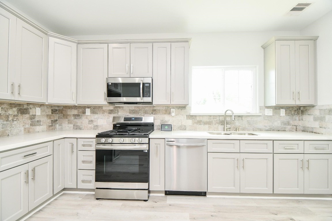 8336 Fountain Street Houston, TX 77051 - Photo 6 of 34 a kitchen with granite countertop white cabinets and white appliances