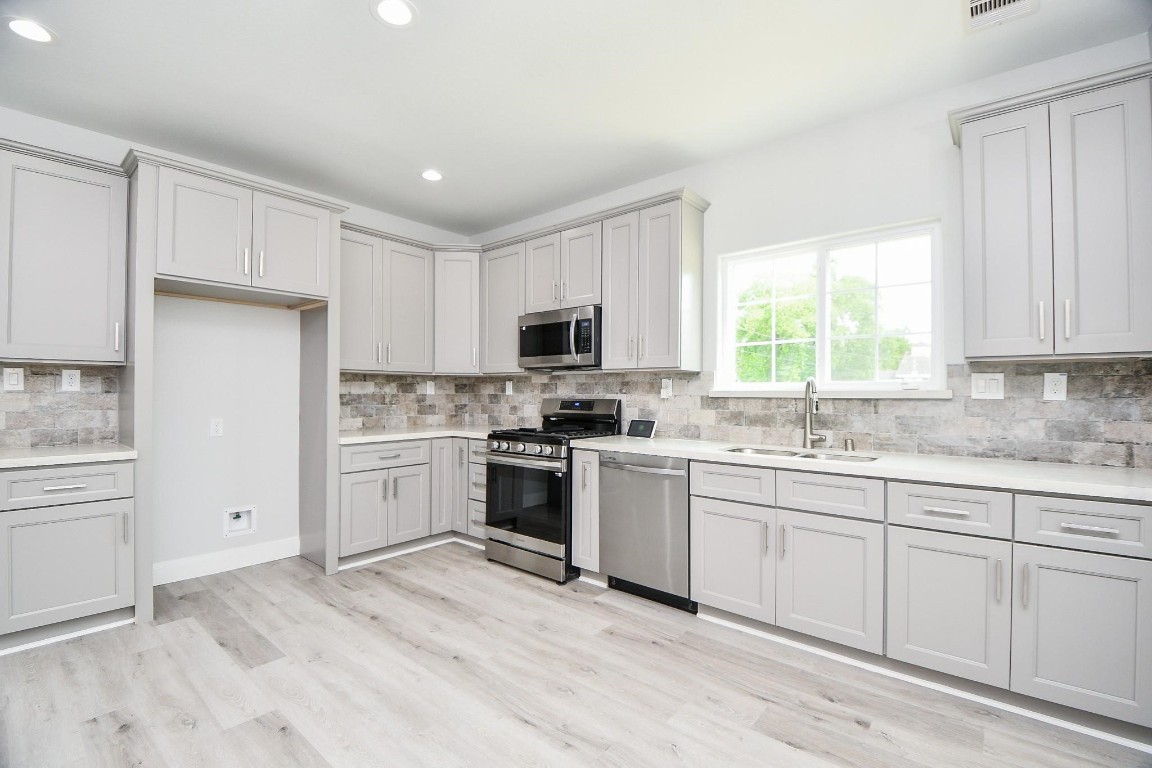 8336 Fountain Street Houston, TX 77051 - Photo 7 of 34 a kitchen with granite countertop white cabinets and white appliances