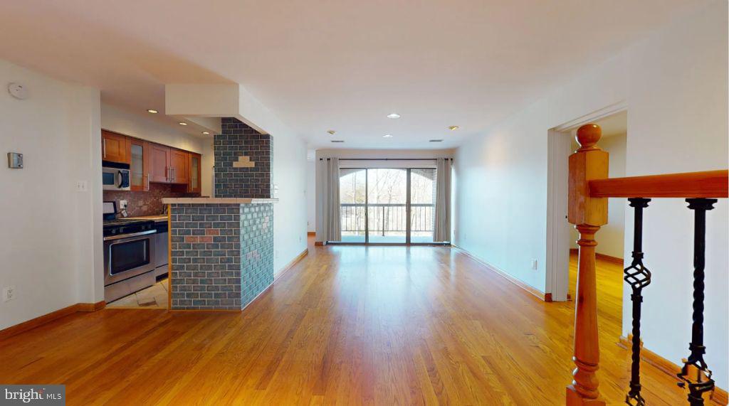 11208 Chestnut Grove Square, Unit 210 Reston, VA 20190 - Photo 10 of 25 a view of kitchen and wooden floor