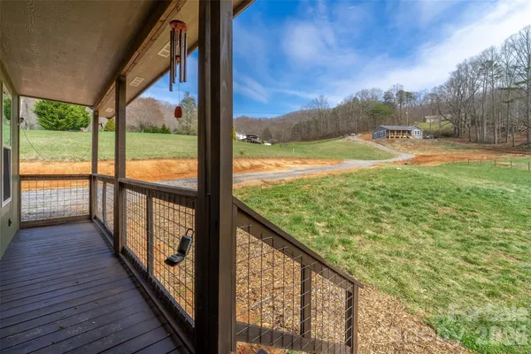 a view of balcony with wooden floor and fence