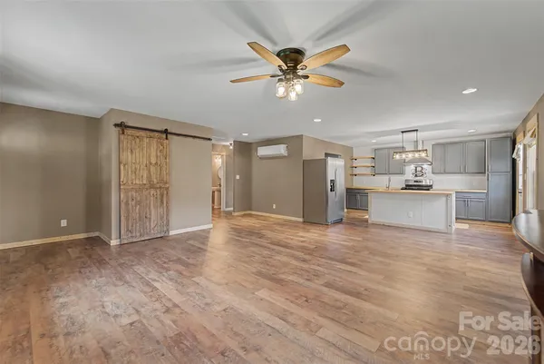 a kitchen with stainless steel appliances a refrigerator sink and microwave