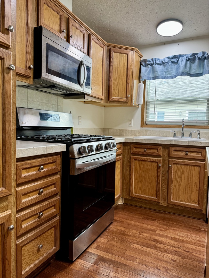 400 James Road Elwood, IL 60421 - Photo 3 of 25 a kitchen with stainless steel appliances granite countertop a stove and a microwave
