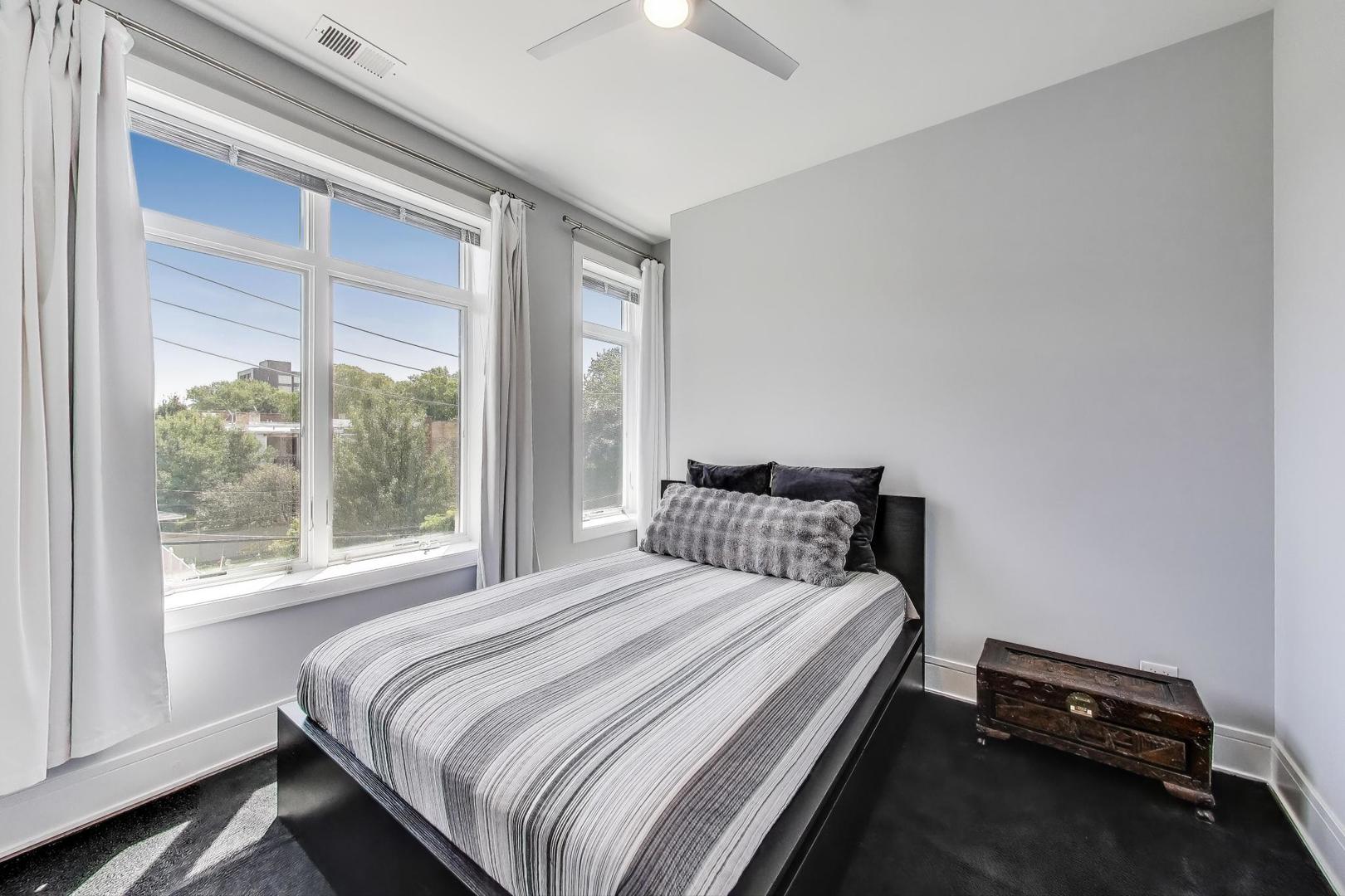 5748 North Hermitage Avenue, Unit 206 Chicago, IL 60660 - Photo 15 of 19 a bedroom with a bed and a window