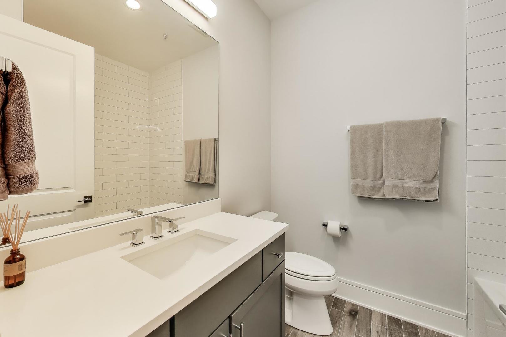 5748 North Hermitage Avenue, Unit 206 Chicago, IL 60660 - Photo 17 of 19 a bathroom with a sink a toilet and mirror